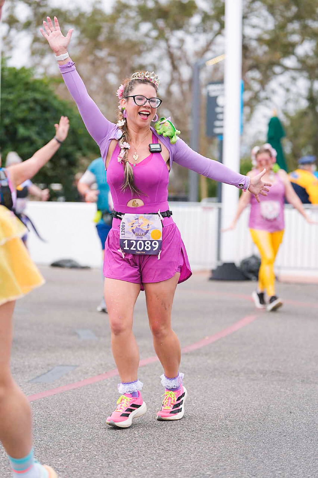 Tabitha at a runDisney event, posing with a medal.
