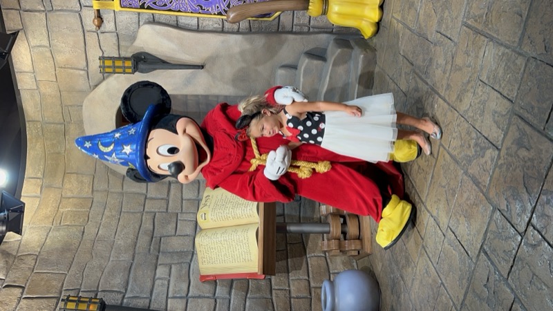 A girl in the blue ballgown laughing on a bench.